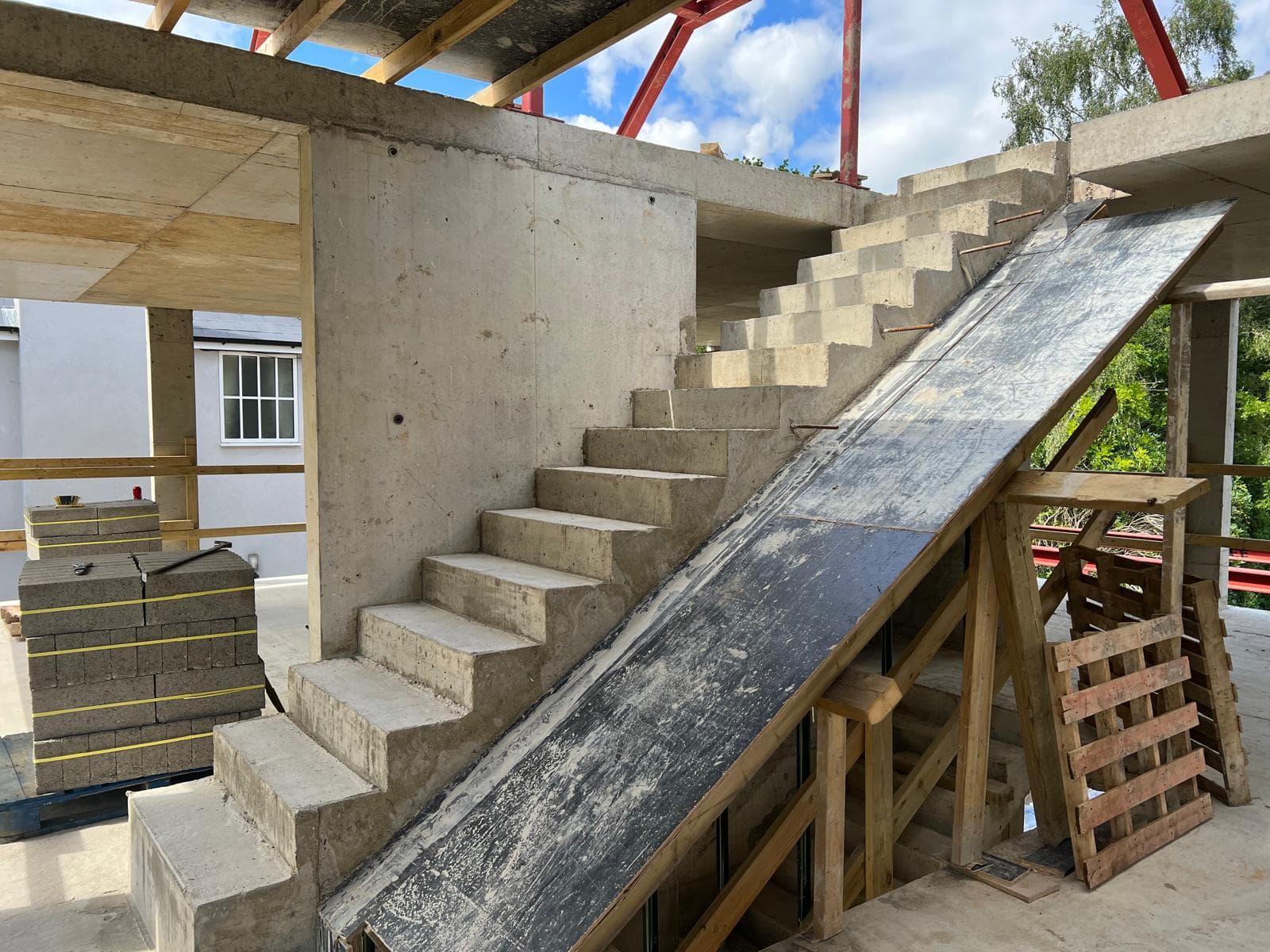 Concrete basement structure with staircase and steel framing at Chobham